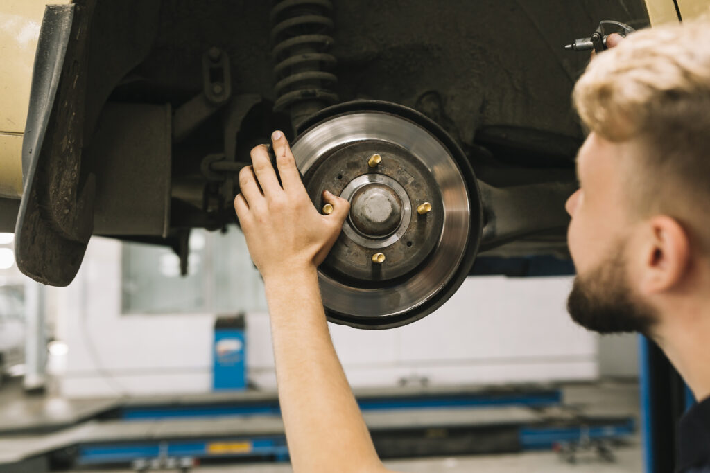 man-looking-checking-brake-rotor