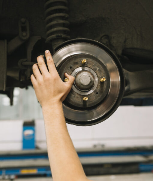 man-looking-checking-brake-rotor